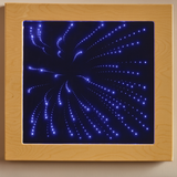 LED light panel with blue starburst pattern inside a wooden frame on a beige wall.