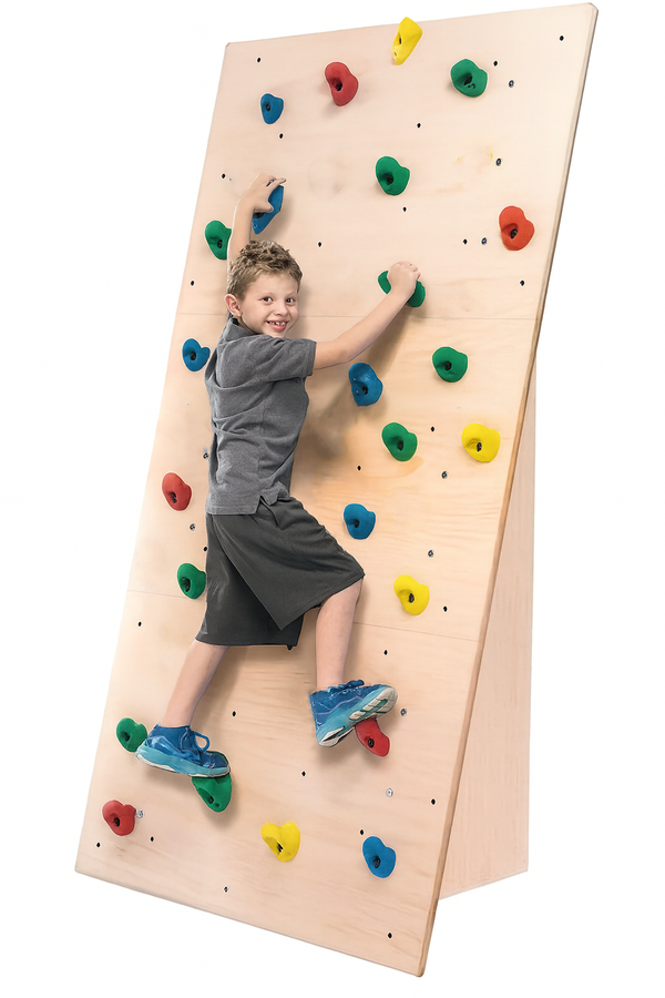 Child climbing a wooden climbing wall with colorful holds on a white background